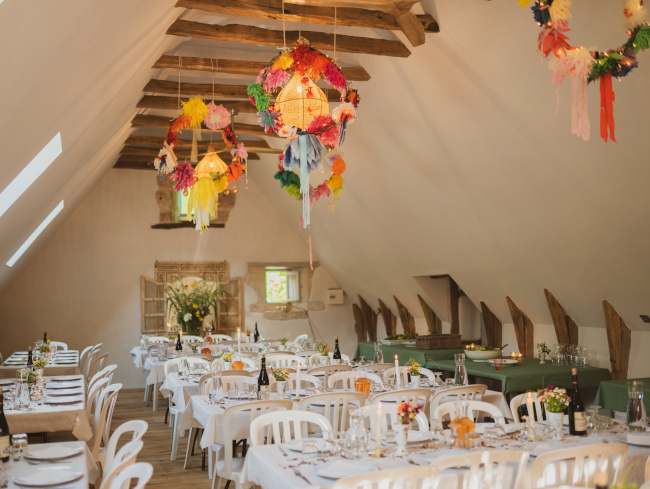 tables in the restored barn set up for a wedding celebration